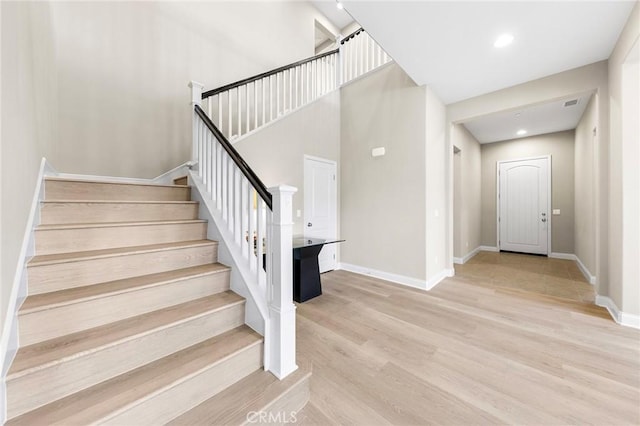 5467 Lisboa St, Chino Hills, CA 91709 - stairway with wood finished floors, baseboards, a high ceiling, and recessed lighting