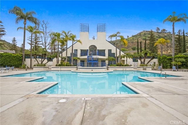 community pool featuring a patio area and a mountain view