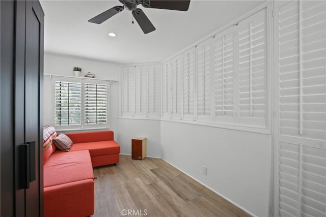 living area featuring wood finished floors, ceiling fan, and recessed lighting