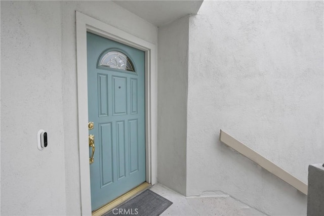 entrance to property with stucco siding