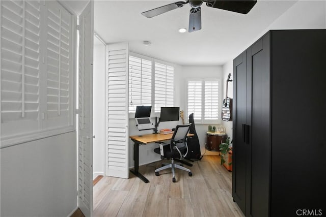 office featuring light wood-style floors and ceiling fan