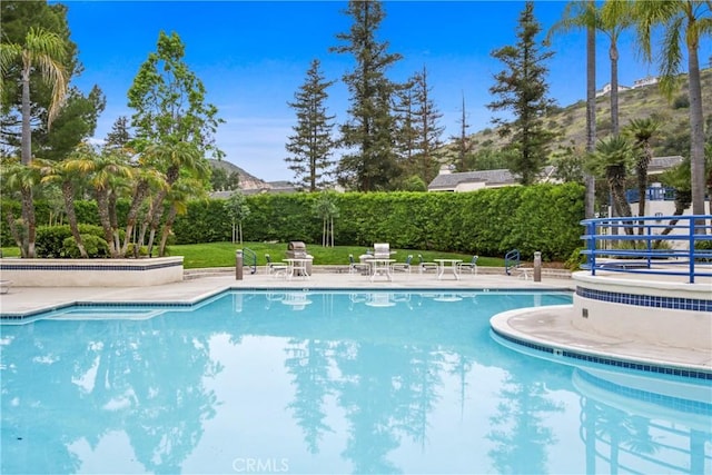 community pool featuring a patio area