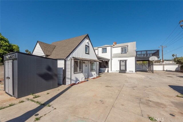 1949 Lancewood Ave, Hacienda Heights, CA 91745 - view of front of home with an outbuilding, a storage unit, and roof with shingles