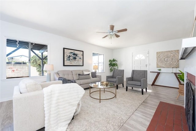 1949 Lancewood Ave, Hacienda Heights, CA 91745 - living area with ceiling fan, light wood-type flooring, a brick fireplace, and baseboards