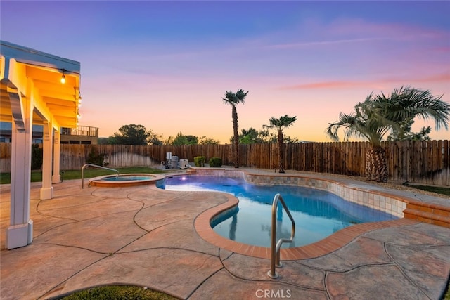 view of swimming pool with a patio area, a pool with connected hot tub, and a fenced backyard