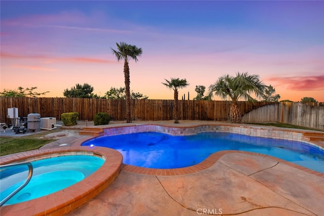 view of pool featuring a patio area, an in ground hot tub, a fenced backyard, and a fenced in pool