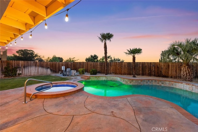 view of pool featuring a fenced backyard, a patio, and a pool with connected hot tub