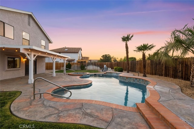view of pool featuring a fenced backyard, a patio, and a pool with connected hot tub