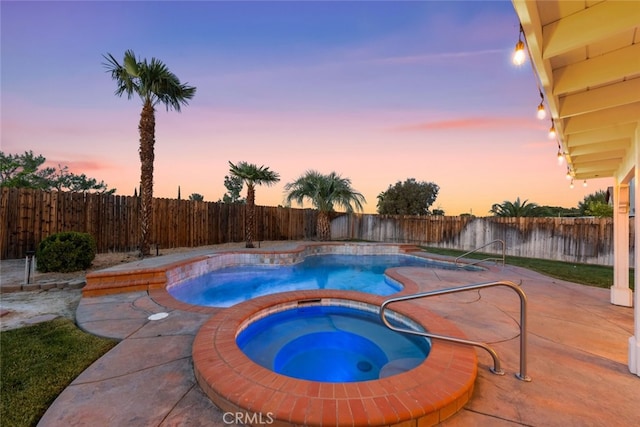 pool at dusk featuring a fenced backyard, an in ground hot tub, a patio, and a fenced in pool