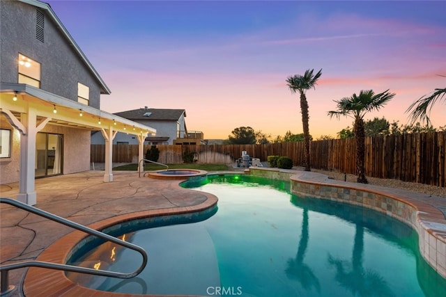 view of swimming pool with an in ground hot tub, a fenced in pool, a fenced backyard, and a patio