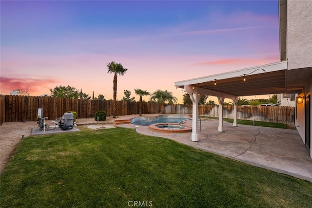 view of yard featuring a fenced backyard, an in ground hot tub, and a patio