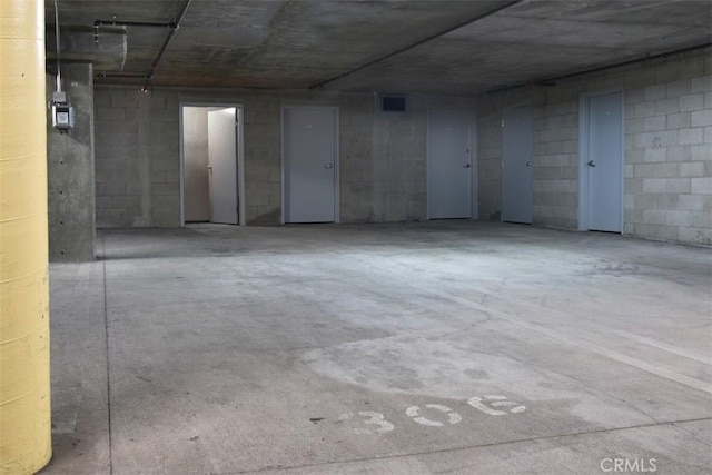 below grade area featuring concrete block wall