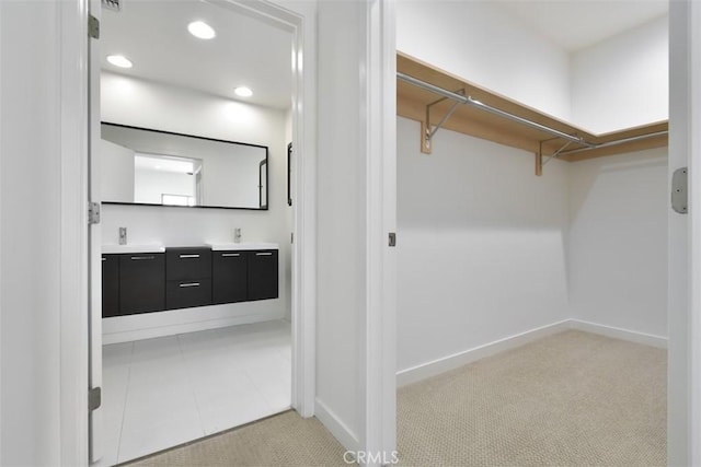 spacious closet with a sink and carpet floors