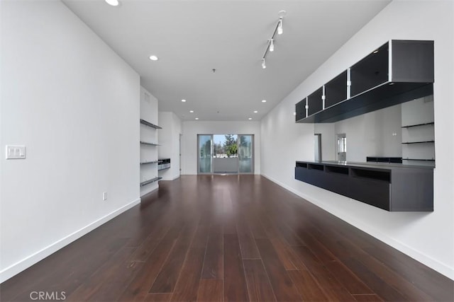 unfurnished living room with recessed lighting, baseboards, and wood finished floors