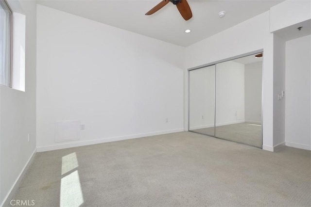 unfurnished bedroom featuring baseboards, a closet, a ceiling fan, and carpet
