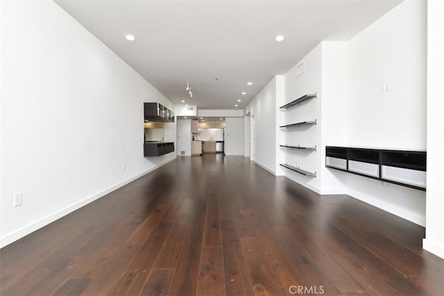 unfurnished living room featuring dark wood finished floors, visible vents, baseboards, and recessed lighting