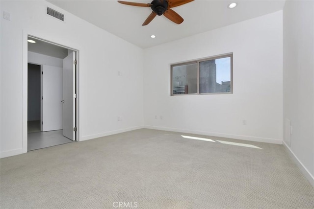 carpeted empty room featuring baseboards, a ceiling fan, visible vents, and recessed lighting