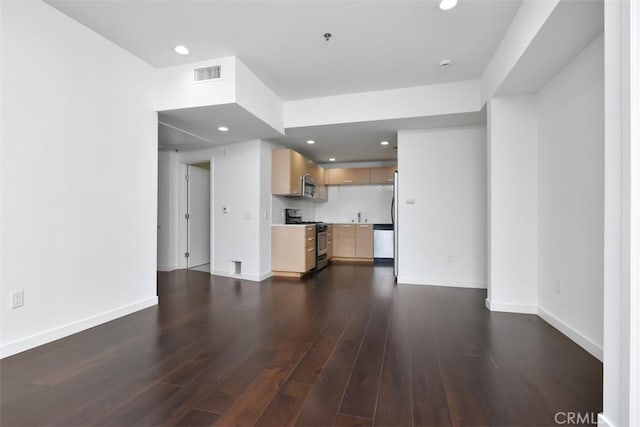 unfurnished living room featuring recessed lighting, baseboards, visible vents, and dark wood finished floors
