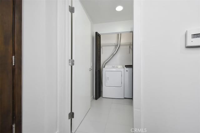 clothes washing area featuring washing machine and clothes dryer, recessed lighting, laundry area, and light tile patterned floors