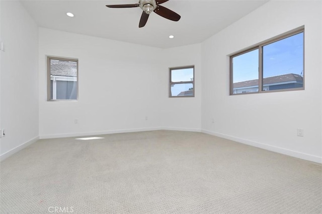 spare room featuring light colored carpet, baseboards, ceiling fan, and recessed lighting