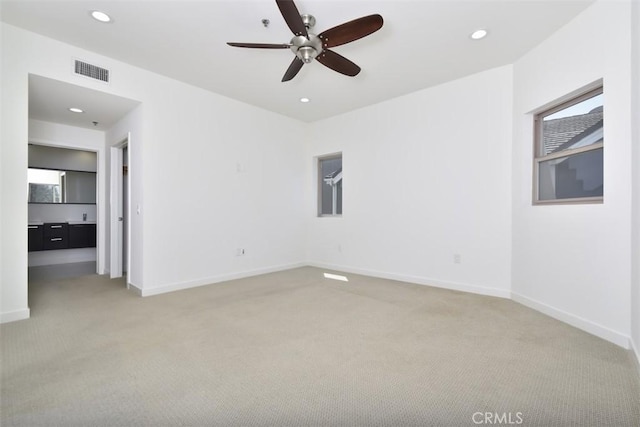spare room with recessed lighting, visible vents, ceiling fan, and light carpet
