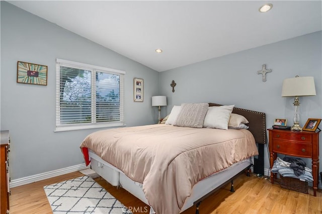 bedroom featuring baseboards, wood finished floors, recessed lighting, and vaulted ceiling