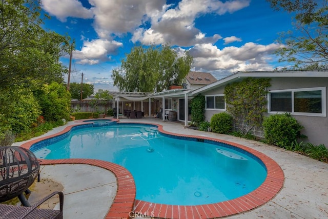 view of swimming pool with a patio area, an in ground hot tub, a fenced in pool, and a fenced backyard