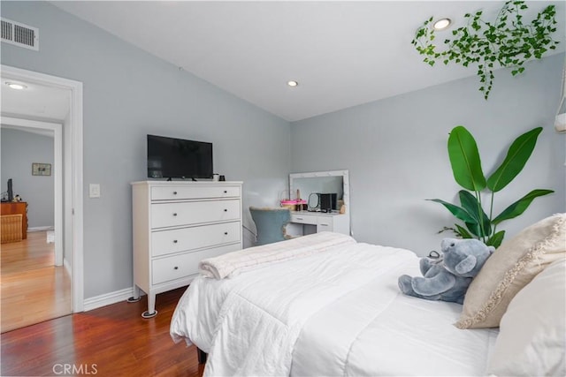 bedroom with recessed lighting, baseboards, visible vents, and wood finished floors