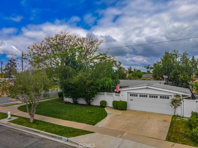 view of front of house with fence, a front lawn, and concrete driveway