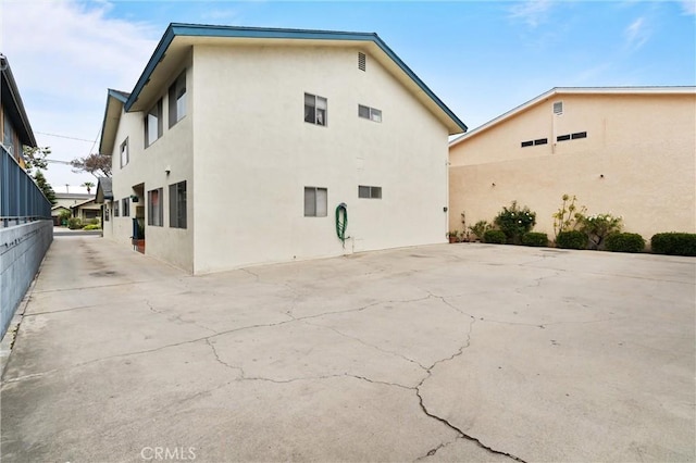 660 Stanley Ave, Long Beach, CA 90814 - view of side of home with a patio area and stucco siding