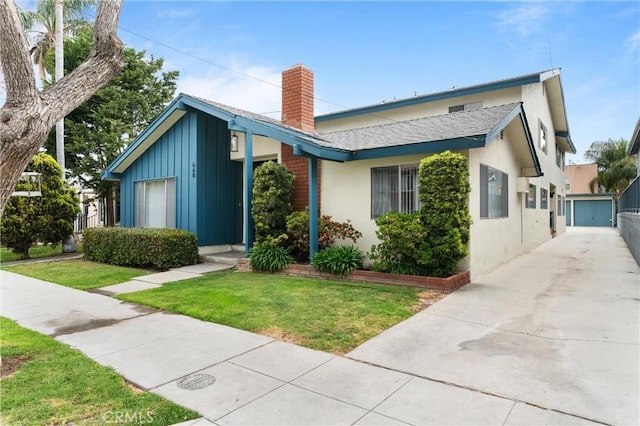 660 Stanley Ave, Long Beach, CA 90814 - view of front of house with stucco siding, a front lawn, a chimney, board and batten siding, and a shingled roof