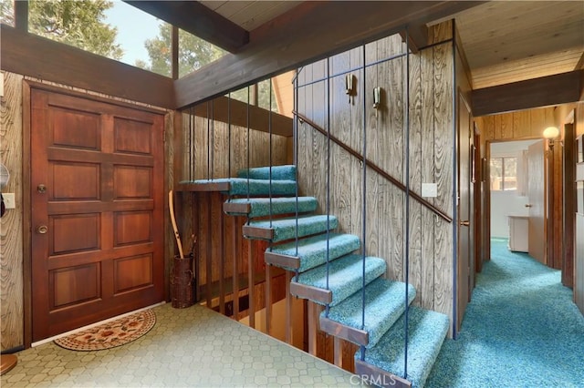 60027 Cascadel Dr S, North Fork, CA 93643 - stairway with carpet, wooden walls, and beam ceiling