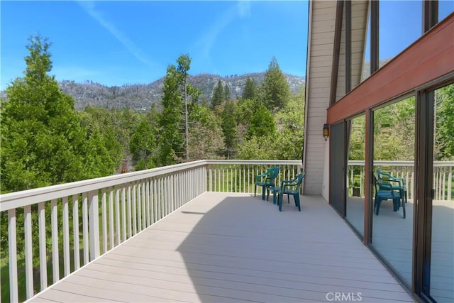 60027 Cascadel Dr S, North Fork, CA 93643 - wooden deck featuring a forest view