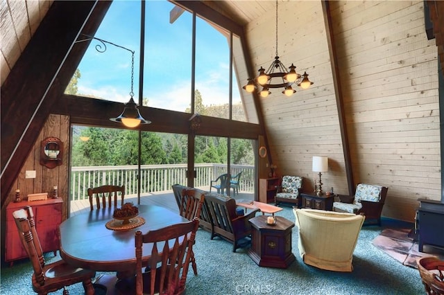 60027 Cascadel Dr S, North Fork, CA 93643 - carpeted dining room featuring a towering ceiling, wood walls, healthy amount of natural light, and a chandelier