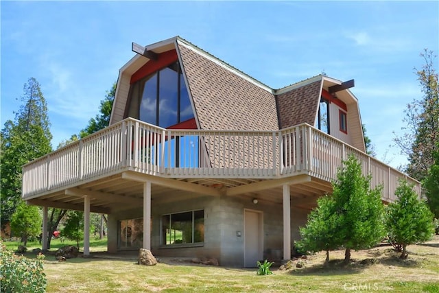 60027 Cascadel Dr S, North Fork, CA 93643 - rear view of house featuring a gambrel roof, roof with shingles, and a wooden deck