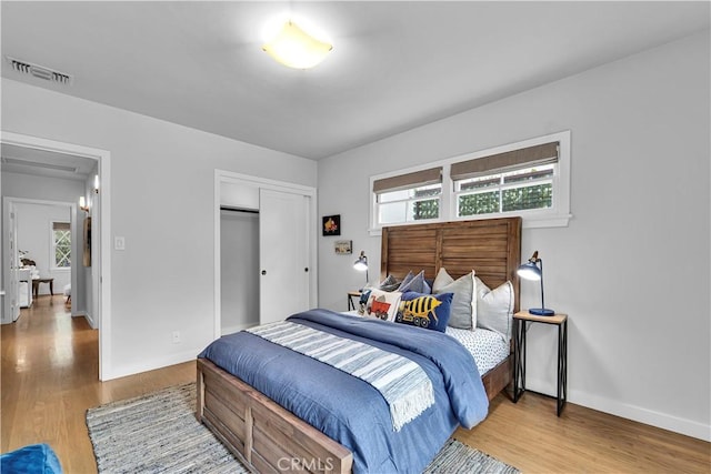 21820 Dumetz Rd, Woodland Hills, CA 91364 - bedroom with wood finished floors, a closet, and baseboards