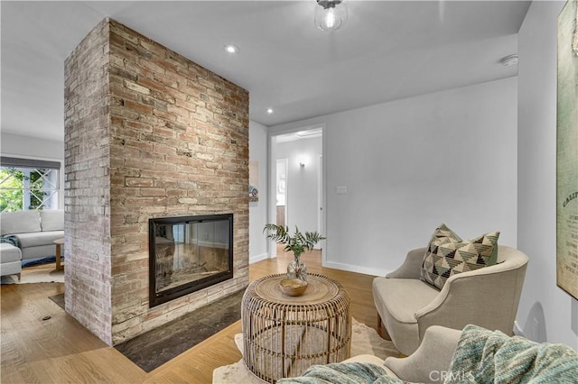 21820 Dumetz Rd, Woodland Hills, CA 91364 - living room with wood finished floors, a brick fireplace, recessed lighting, and baseboards