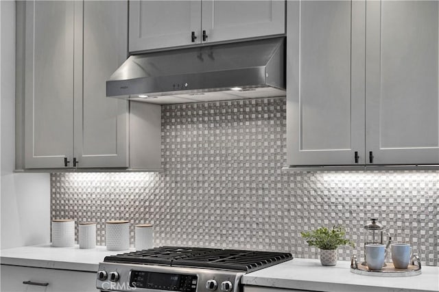 21820 Dumetz Rd, Woodland Hills, CA 91364 - kitchen featuring under cabinet range hood, stainless steel range with gas stovetop, and decorative backsplash