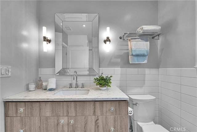 21820 Dumetz Rd, Woodland Hills, CA 91364 - bathroom with vanity, tile walls, and a wainscoted wall