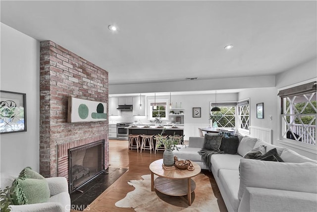 21820 Dumetz Rd, Woodland Hills, CA 91364 - living room featuring a fireplace, wood finished floors, recessed lighting, and wainscoting