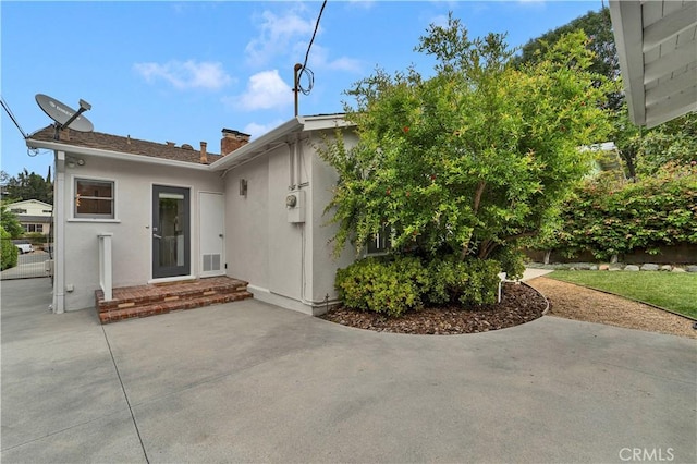 21820 Dumetz Rd, Woodland Hills, CA 91364 - view of front of home with a patio, stucco siding, and a chimney