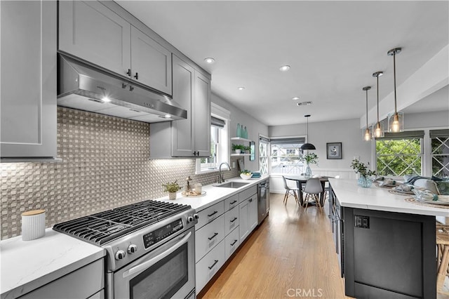 21820 Dumetz Rd, Woodland Hills, CA 91364 - kitchen with stainless steel appliances, under cabinet range hood, a sink, gray cabinets, and recessed lighting
