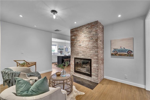 21820 Dumetz Rd, Woodland Hills, CA 91364 - living room with a brick fireplace, baseboards, light wood-style flooring, and recessed lighting