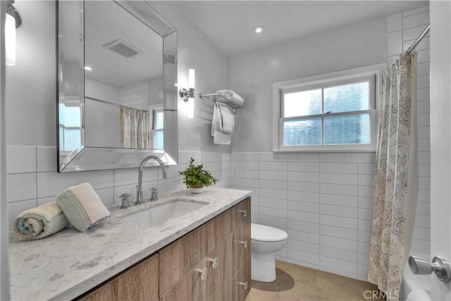 21820 Dumetz Rd, Woodland Hills, CA 91364 - full bathroom with tile walls, tile patterned flooring, vanity, a shower with shower curtain, and a wainscoted wall