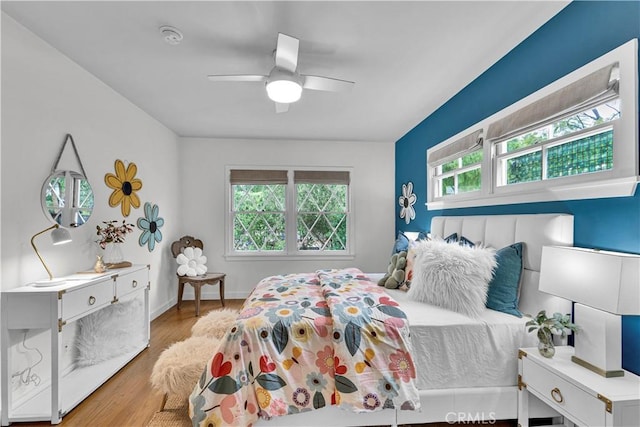 21820 Dumetz Rd, Woodland Hills, CA 91364 - bedroom featuring multiple windows, wood finished floors, and a ceiling fan