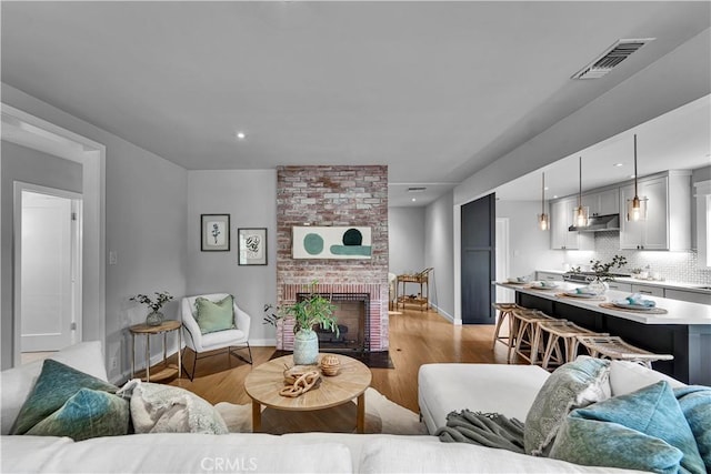21820 Dumetz Rd, Woodland Hills, CA 91364 - living room with light wood-style floors and a fireplace