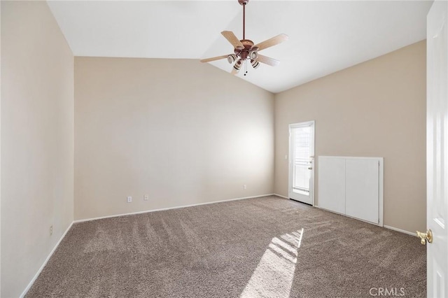 carpeted spare room featuring high vaulted ceiling, baseboards, and a ceiling fan
