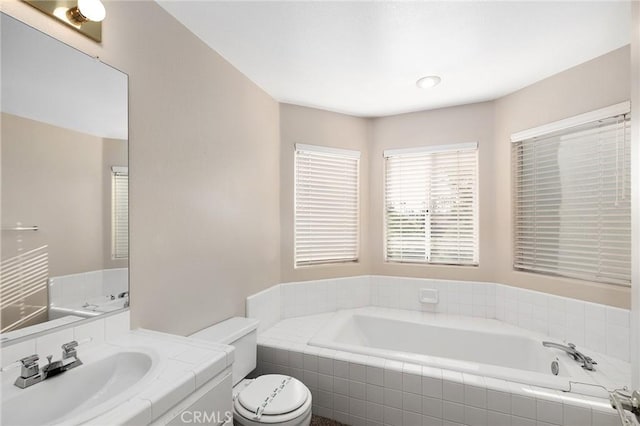 full bathroom featuring a bath, toilet, and vanity