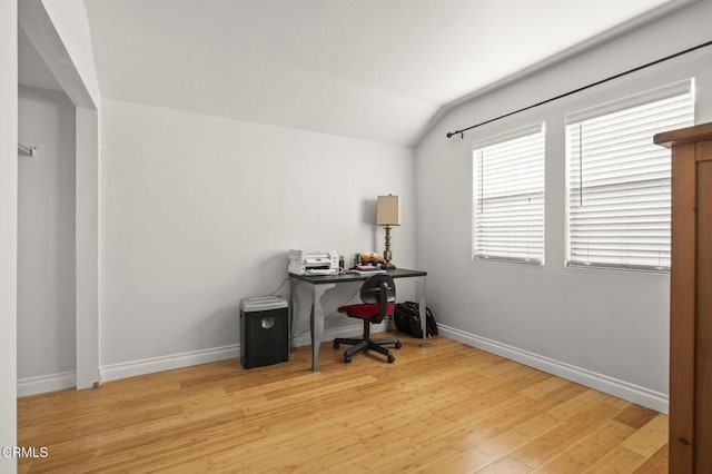 office space featuring baseboards, wood finished floors, and lofted ceiling
