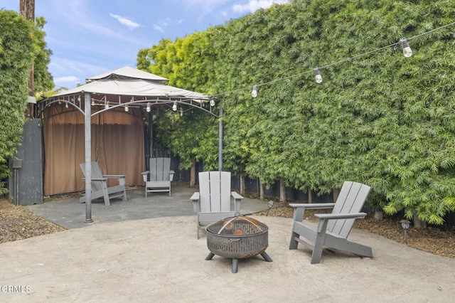 view of patio / terrace featuring an outdoor fire pit and a gazebo
